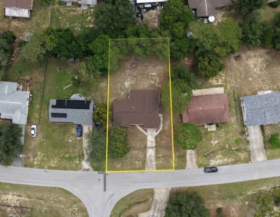 An aerial view shows a single-story house with a brown roof on a rectangular lot — 457 WATER ROAD, OCALA, FL