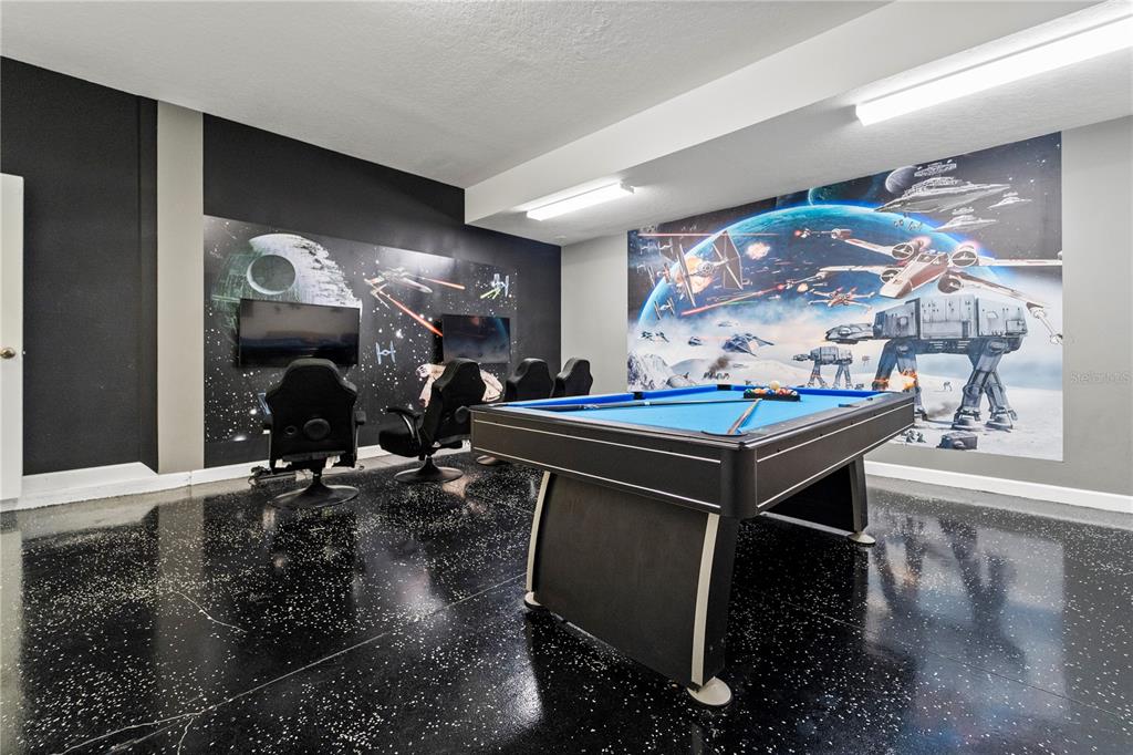 A game room features a pool table, gaming chairs, and Star Wars-themed wall murals — 1571 PALMERO WAY, CHAMPIONS GATE, FL