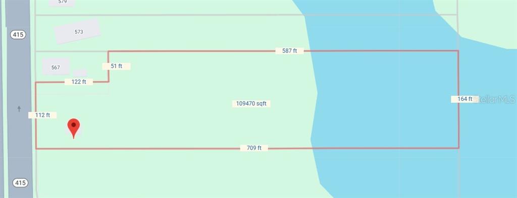 This map shows the property boundaries and dimensions of a waterfront lot — 561 N SR 415, OSTEEN, FL