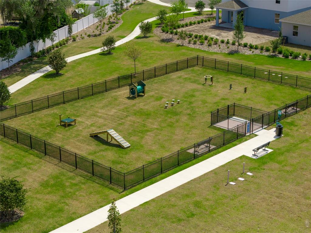 An aerial view of a fenced-in dog park with agility equipment and a paved walkway — 5949 SOPHIEANN STREET, ST CLOUD, FL