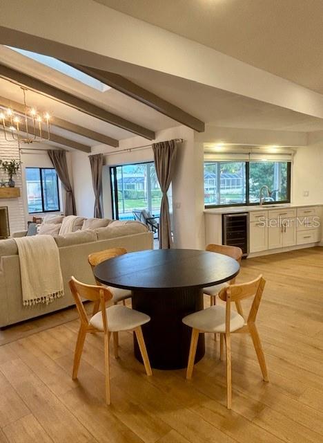 A dining area with a round table and chairs sits before a living room and kitchen — 13 COLONIA COURT, PALM COAST, FL