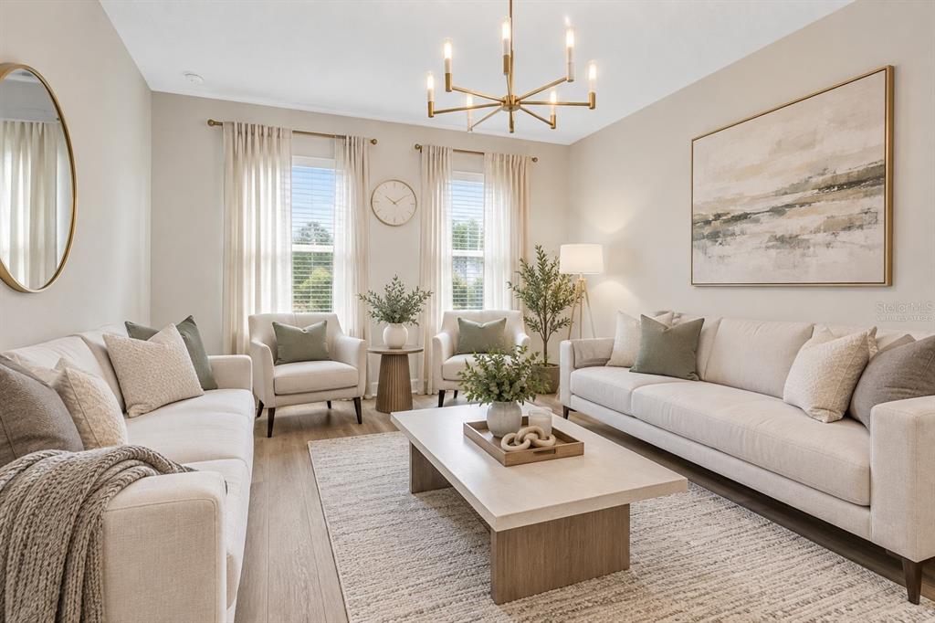 A formal living room features ornate gold-trimmed furniture, a crystal chandelier, and beige curtains — 10169 SPRING LAKE DRIVE, CLERMONT, FL
