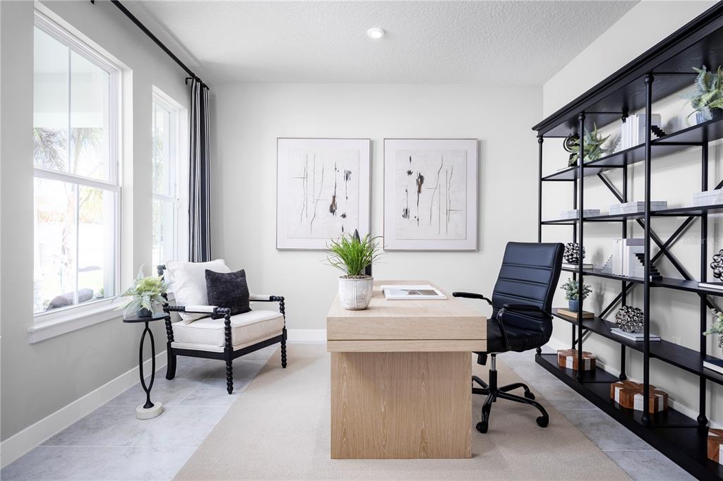 A home office features a light wood desk, black leather chair, and a tall metal bookshelf — 22145 PINE GROVE LOOP, LEESBURG, FL