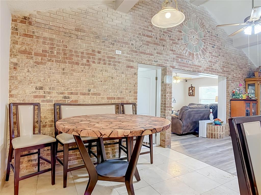 A screened-in patio features a long wicker sofa, dining set, and ceiling fans — 1123 W HANCOCK DRIVE, DELTONA, FL