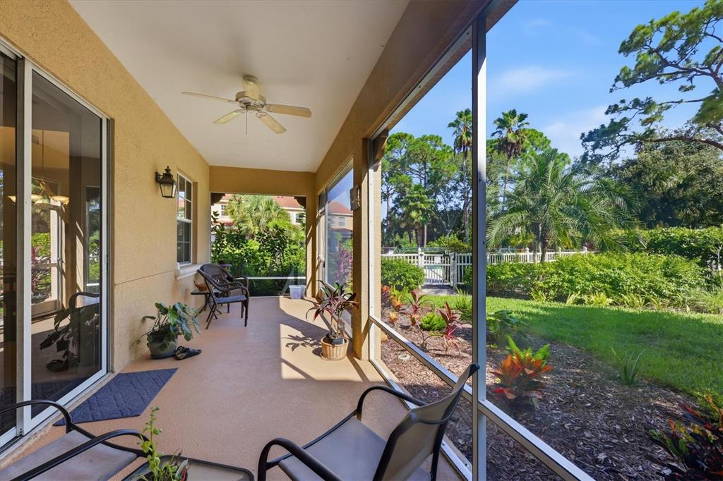 A screened-in patio with a ceiling fan, outdoor furniture, and a view of the yard — 3971 SQUARE EAST LANE UNIT 8, SARASOTA, FL
