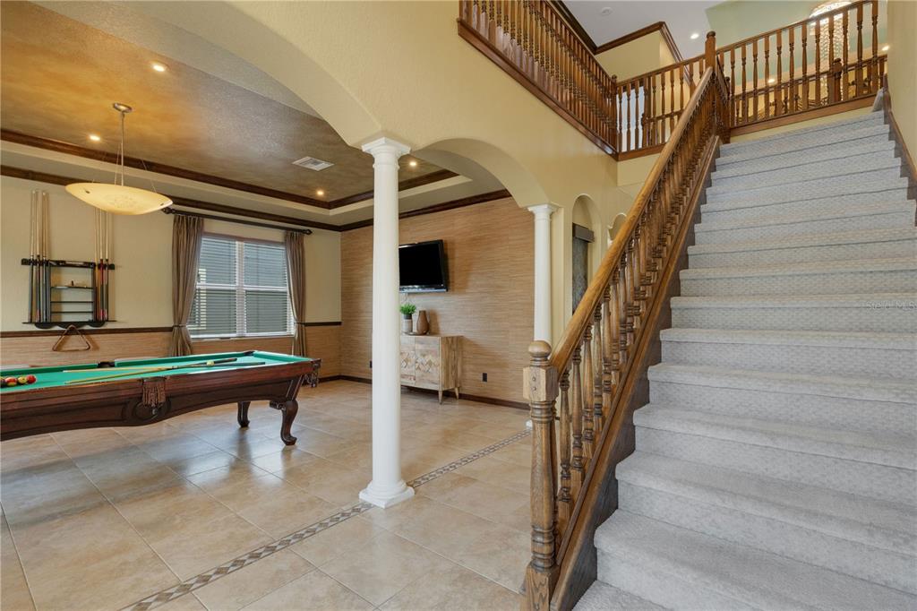 A two-story house with a paved driveway, a front porch, and a large palm plant — 3021 59TH AVENUE S, ST PETERSBURG, FL