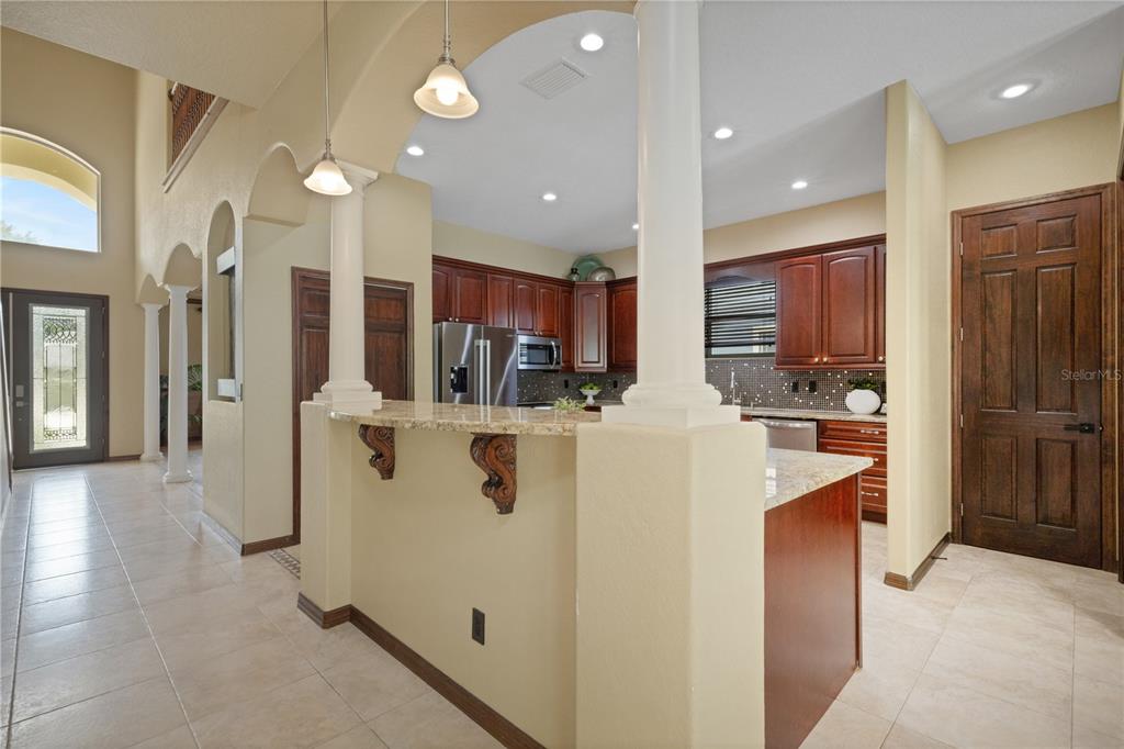A two-story house with a red tile roof, beige stucco walls, and a paved driveway — 3021 59TH AVENUE S, ST PETERSBURG, FL