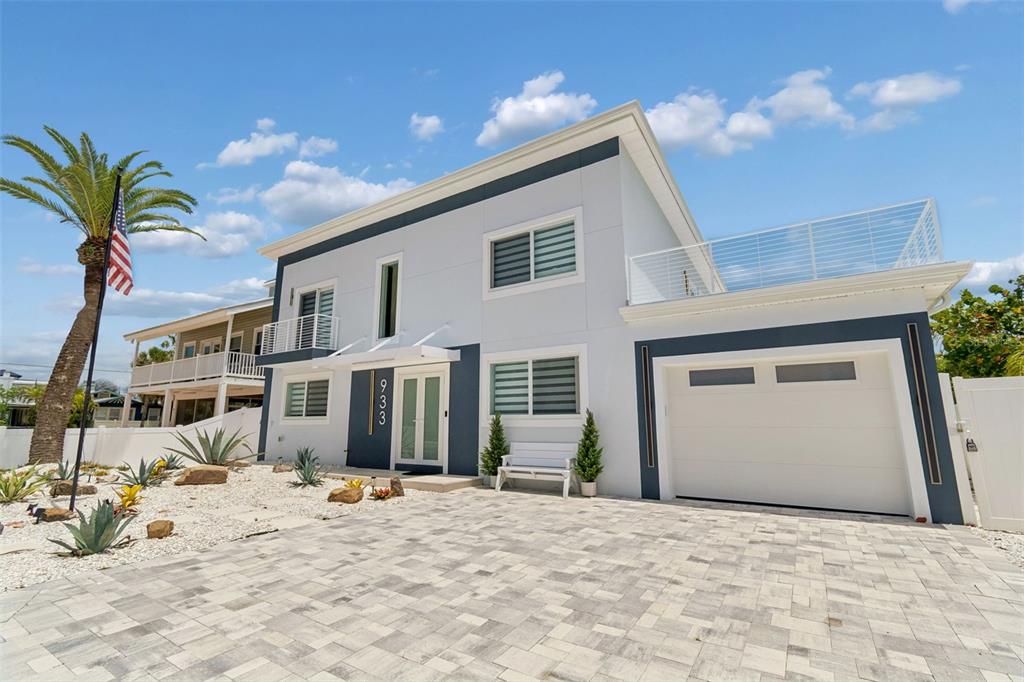 A two-story modern house with a white exterior, gray accents, and a paved driveway — 933 ELDORADO AVENUE, CLEARWATER BEACH, FL