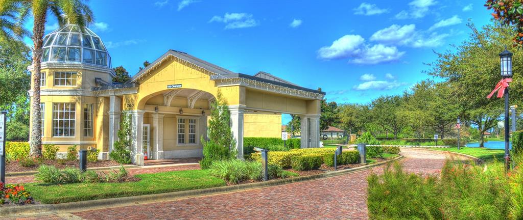 A yellow building with a glass dome and a covered entrance sits beside a brick road — 350 HIBISCUS WAY, PALM COAST, FL