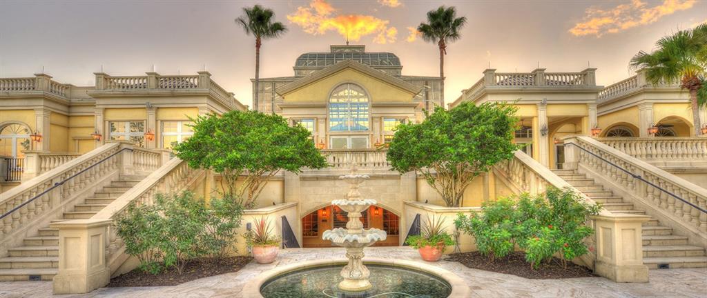 A grand mansion exterior features a central fountain, symmetrical staircases, and a glass-domed roof — 350 HIBISCUS WAY, PALM COAST, FL
