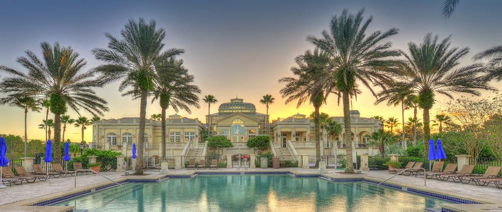 A swimming pool sits in front of a large, multi-story building with palm trees — 350 HIBISCUS WAY, PALM COAST, FL