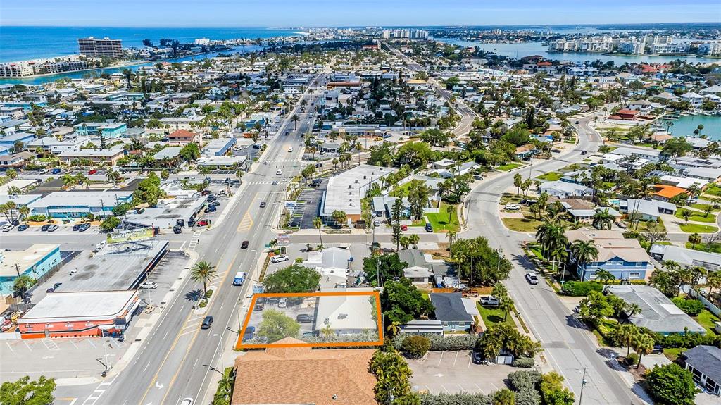 An aerial view of a coastal neighborhood with a property outlined in orange — 6655 GULF BOULEVARD, ST PETE BEACH, FL
