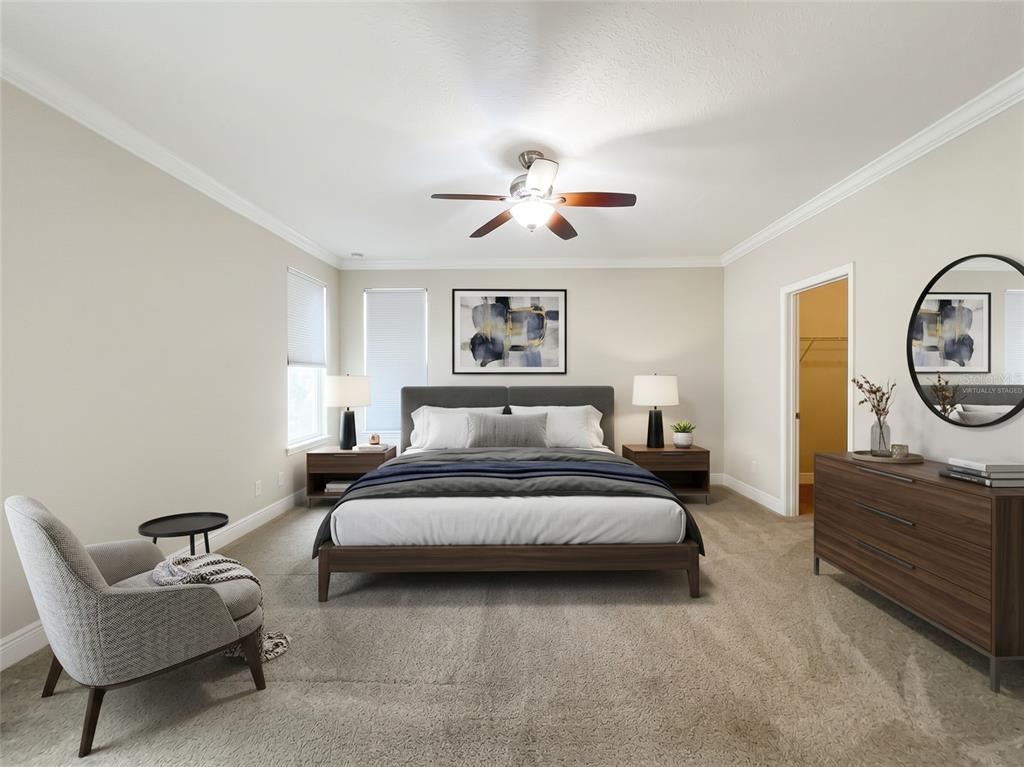 An open-concept living room and kitchen featuring tile floors, dark cabinetry, and two dark sofas — 8461 GREIDER WAY, ORLANDO, FL