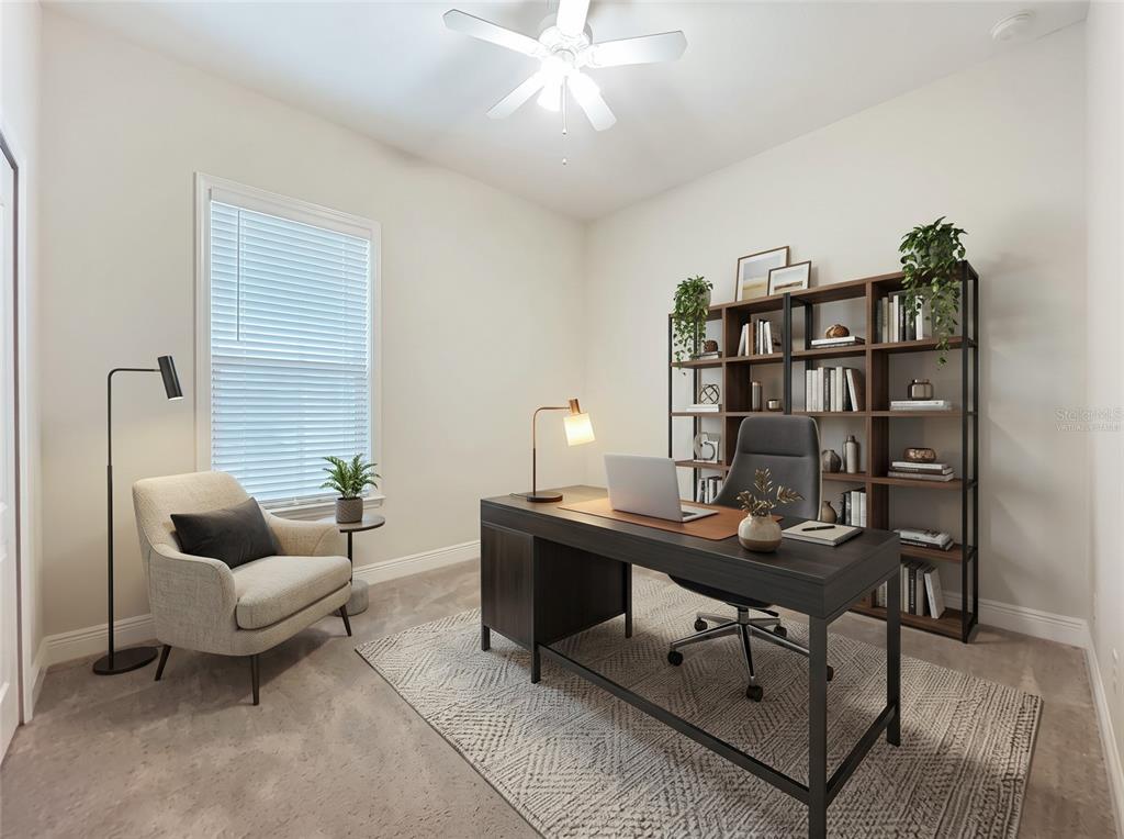 A living room with tile floors, two dark sofas, a television, and a ceiling fan — 8461 GREIDER WAY, ORLANDO, FL