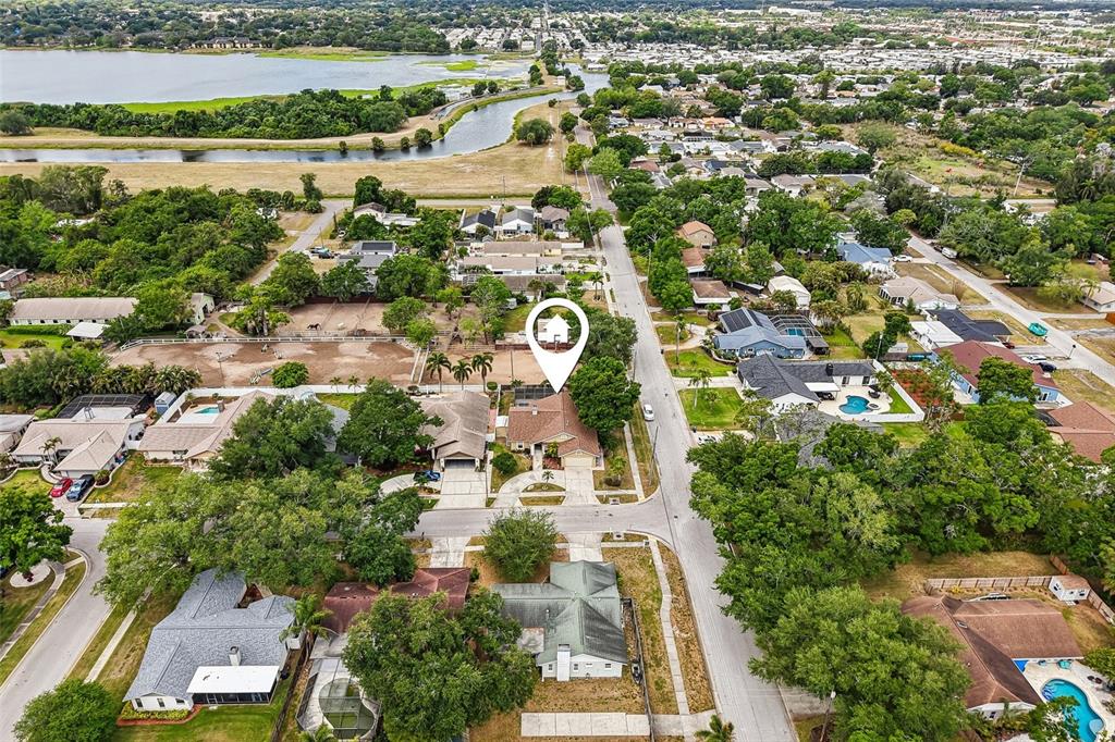 An aerial view shows a residential neighborhood with a house marked by a location pin — 12596 93RD WAY, LARGO, FL