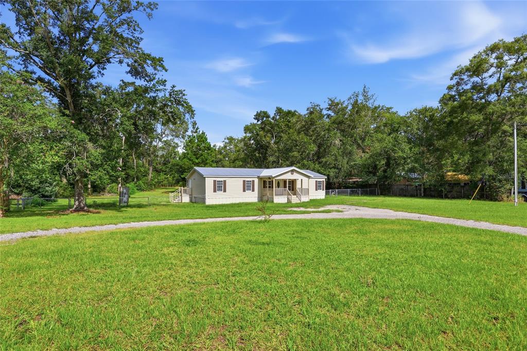 An aerial view shows a house with a metal roof, a shed, and a carport — 9528 NW 235TH TERRACE, ALACHUA, FL