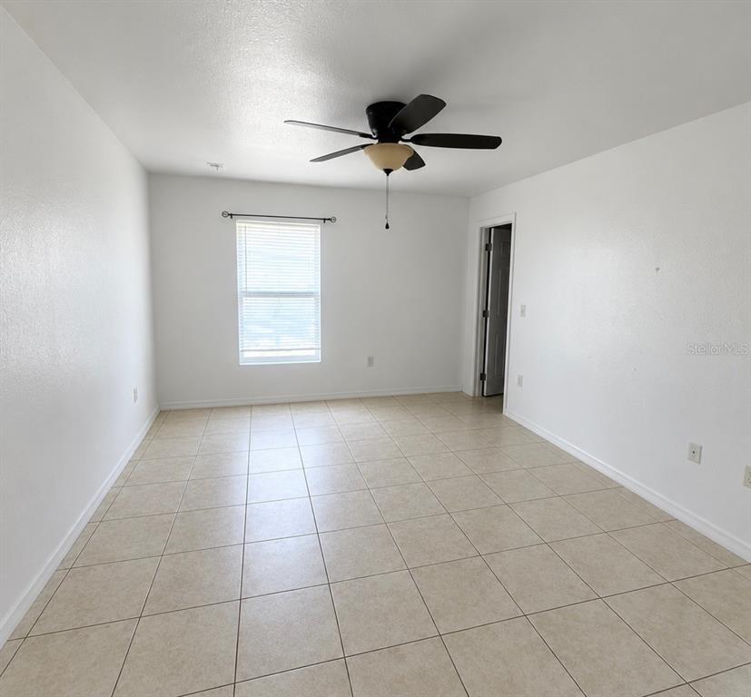 A kitchen with dark wood cabinets, granite countertops, stainless steel appliances, and tile flooring — 61 WALNUT DRIVE, OCALA, FL
