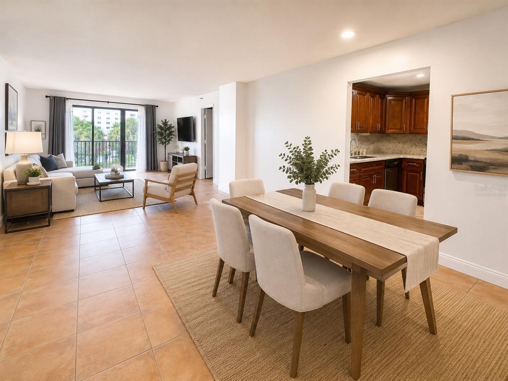 An open-concept living and dining area features tile floors, a wooden dining table, and balcony access — 1201 S OCEAN DRIVE UNIT 314S, HOLLYWOOD, FL