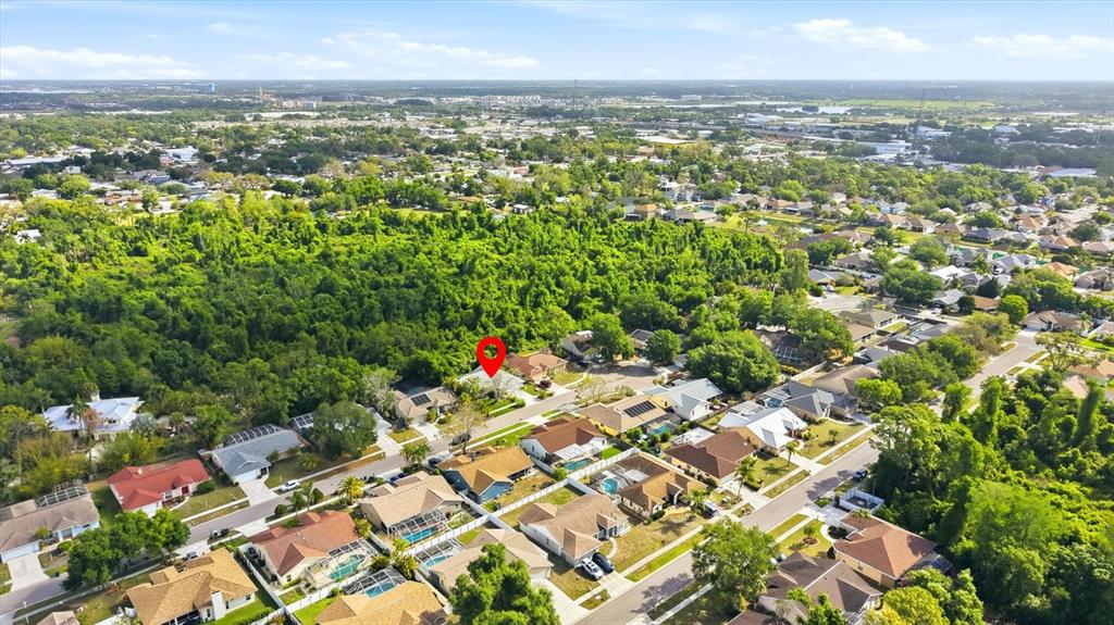An aerial view shows a residential neighborhood with a red location pin on a house — 5599 WILDE OAK WAY, SARASOTA, FL