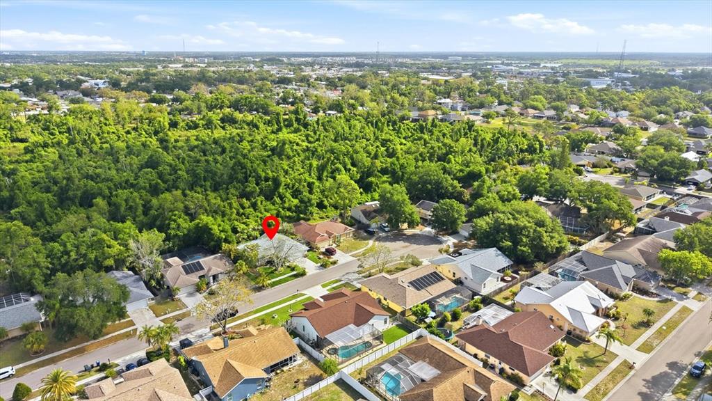 An aerial view shows a suburban neighborhood with a red pin marking a single-family home — 5599 WILDE OAK WAY, SARASOTA, FL