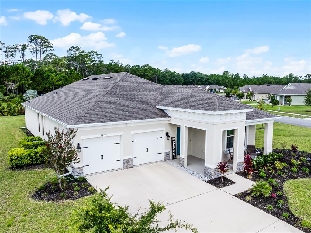 An aerial view of a single-story house with a two-car garage and landscaped yard — 2892 MONAGHAN DRIVE, ORMOND BEACH, FL