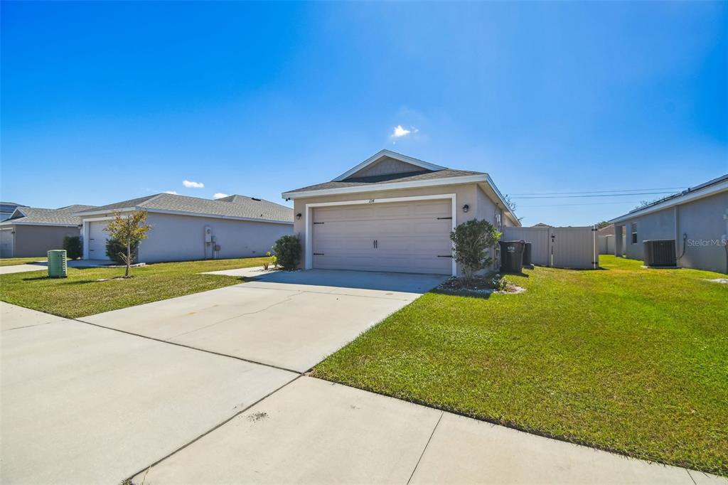 A single-story suburban house with a two-car garage and a concrete driveway — 114 EAGLE SUMMIT DRIVE, RUSKIN, FL