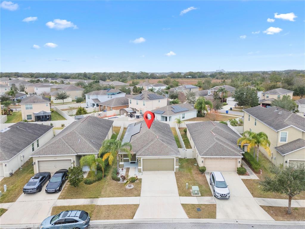An aerial view shows a suburban neighborhood with a single-family home marked by a pin — 15407 LOST CREEK LANE, RUSKIN, FL