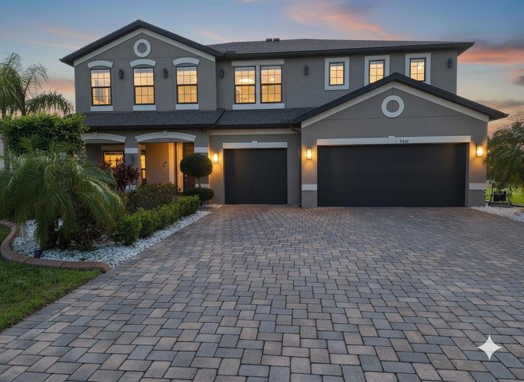 An aerial view shows a gated residential community entrance with a pond and landscaped grounds — 9410 LISBON STREET, SEFFNER, FL