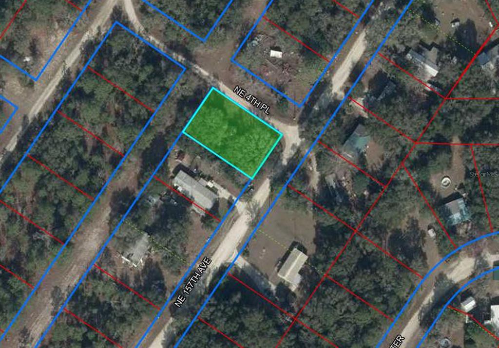 This is an aerial map view showing a vacant, rectangular lot highlighted in green — 15950 NE 4TH PLACE, WILLISTON, FL