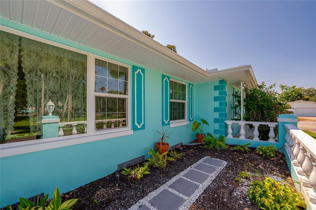 An entryway features a white front door, built-in shelving, hardwood floors, and a console table — 697 JOHN ANDERSON DRIVE, ORMOND BEACH, FL