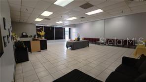 A large, open commercial space features white tile flooring, drop ceilings, and a reception desk — 2921 S ORLANDO DRIVE UNIT 178, SANFORD, FL