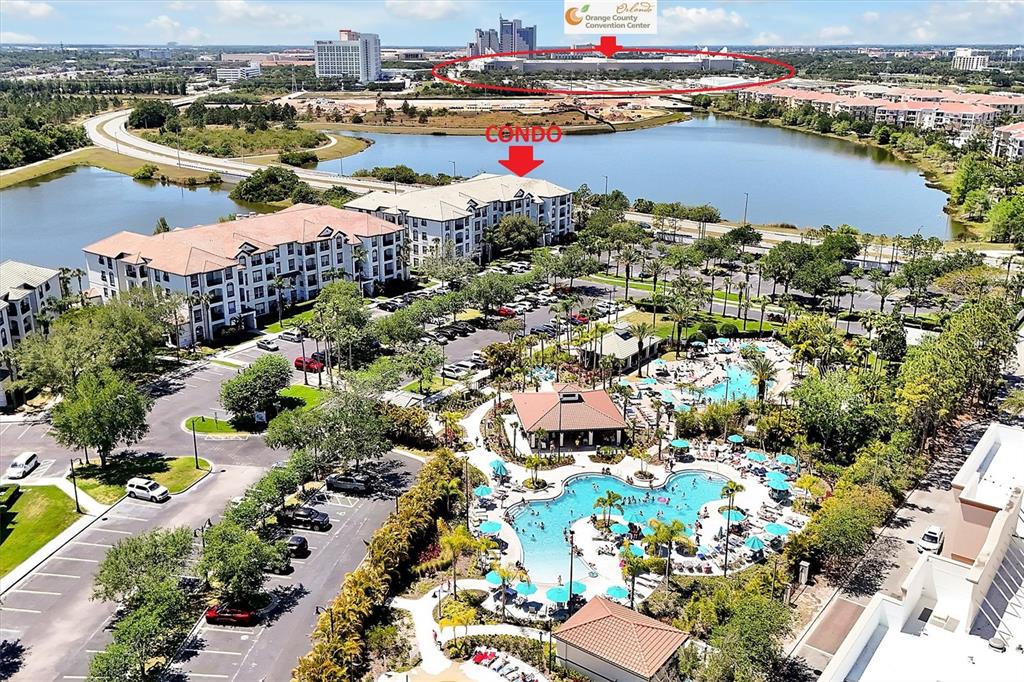 An aerial view shows a condominium complex with a swimming pool and a nearby convention center — 4126 BREAKVIEW DRIVE UNIT 30701, ORLANDO, FL