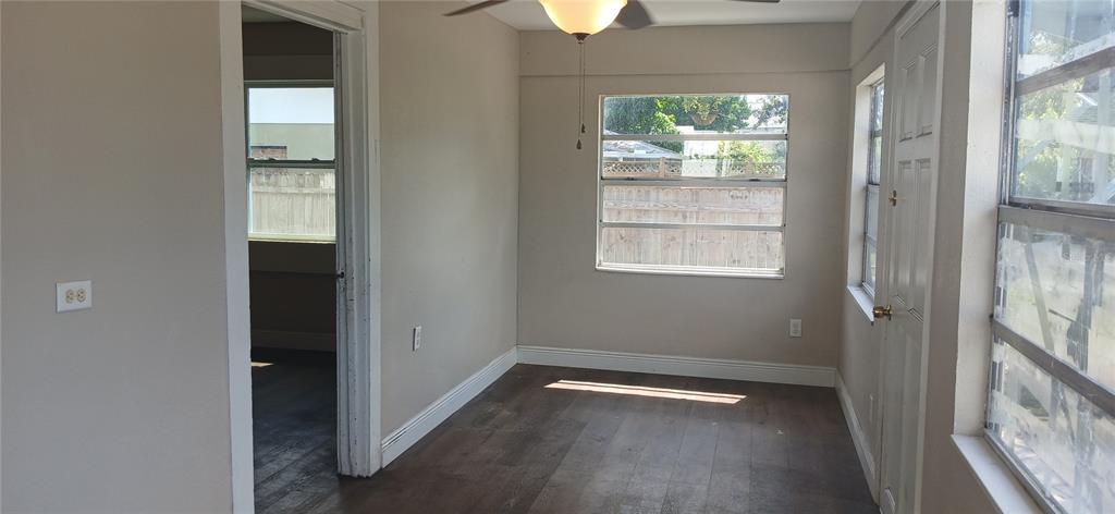 An interior room with wood-look flooring, a ceiling fan, and a doorway leading to another room — 2055 28TH AVENUE N, ST PETERSBURG, FL