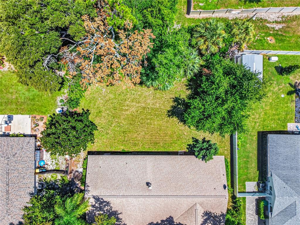 An aerial view shows a residential backyard with a lawn, trees, and neighboring houses — 301 VALENCIA COURT, WINTER GARDEN, FL