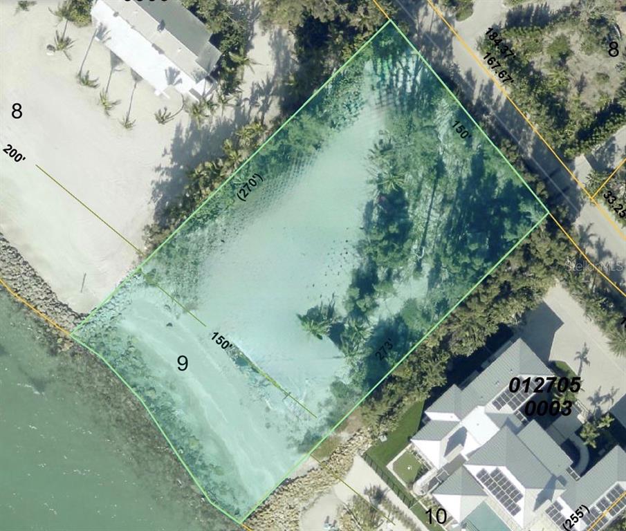 A view of a sandy beach with crashing waves under a cloudy, overcast sky — 7740 SANDERLING ROAD, SARASOTA, FL