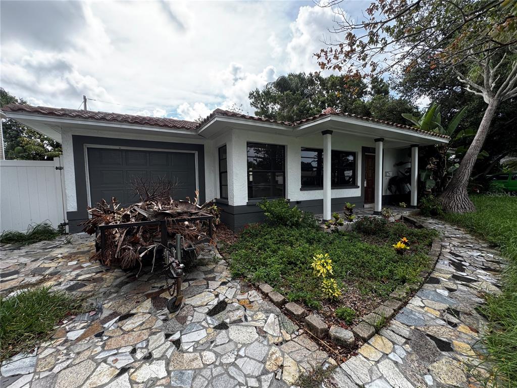 A single-story house with a stone-paved driveway, a trailer, and a covered front porch — 3249 54TH STREET N, ST PETERSBURG, FL
