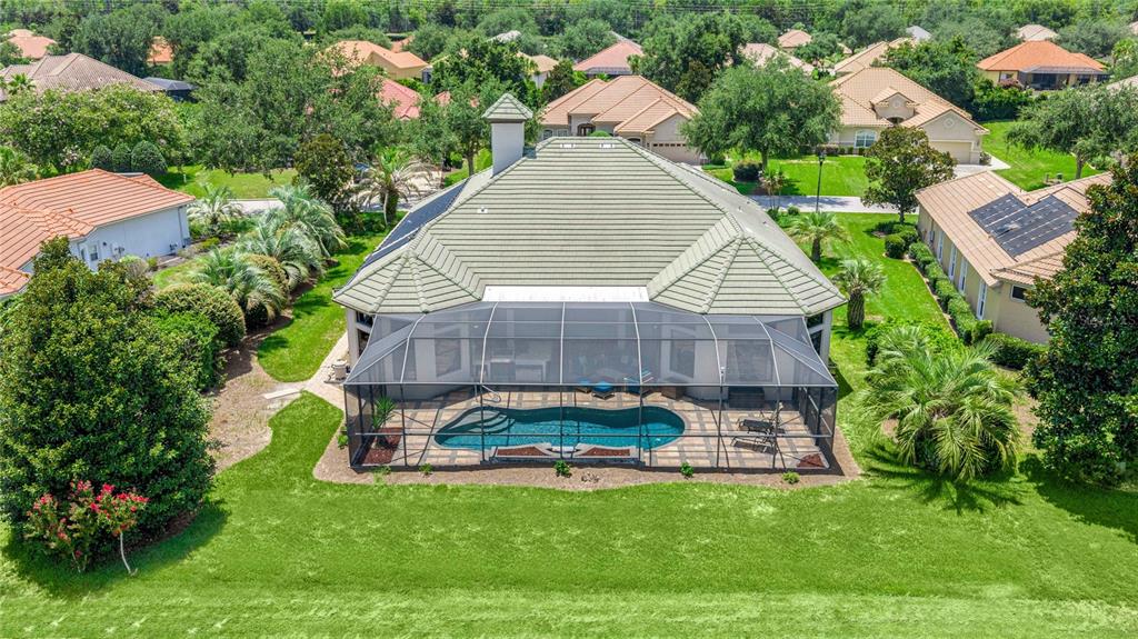 An aerial view of a house with a screened-in pool and a tiled roof — 1575 N EAGLE RIDGE PATH, HERNANDO, FL
