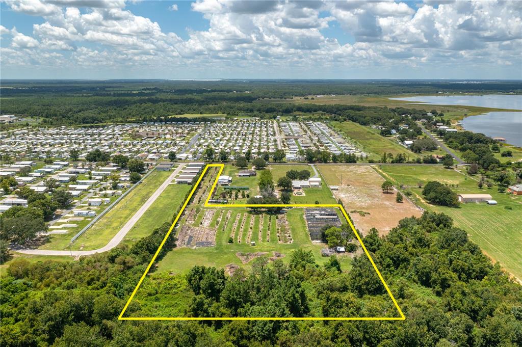 An aerial view shows a large, L-shaped parcel of land outlined in yellow — 0 KEEN ROAD, FROSTPROOF, FL