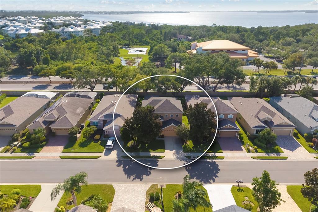 An aerial view shows a residential house circled in a neighborhood near a large body — 3628 SUMMERWIND CIRCLE, BRADENTON, FL