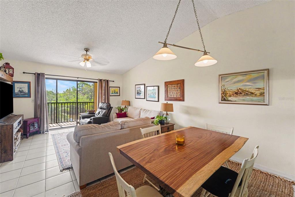 A kitchen features white cabinets with red panels, a double sink, and white appliances — 1702 SEASCAPE CIRCLE UNIT 203, TARPON SPRINGS, FL