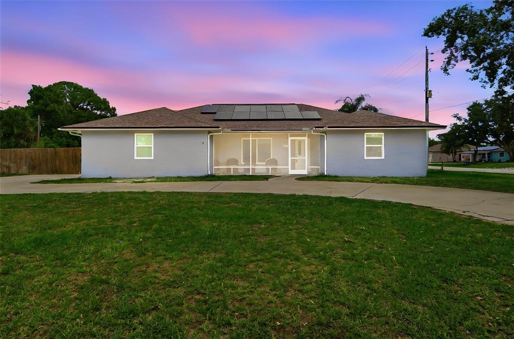 A living room with light wood floors, a vaulted ceiling, a bar, and a sectional sofa — 602 LAKE DRIVE, SEBASTIAN, FL