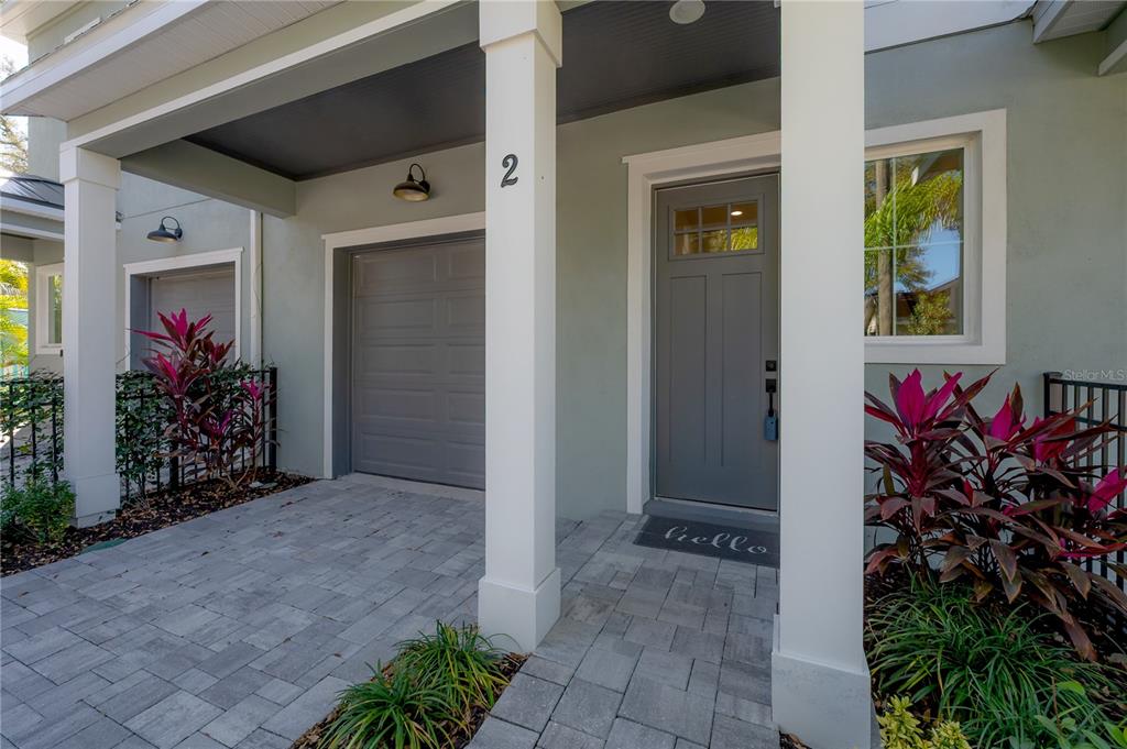 A paved path winds alongside a lake bordered by trees and yellow bollards — 5530 N 9TH STREET UNIT 2, TAMPA, FL