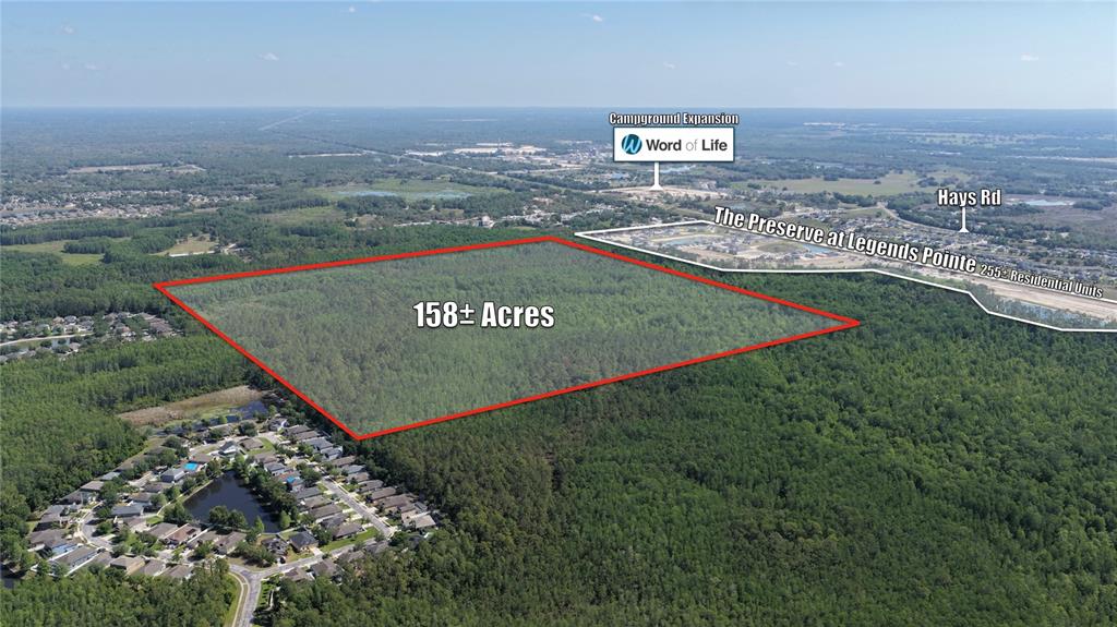 An aerial view shows a large, rectangular wooded plot of land outlined in red — ROBIN RIDGE TRAIL, HUDSON, FL