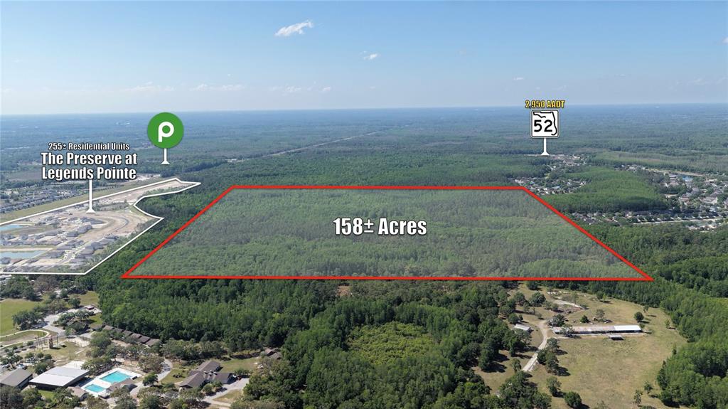 This aerial view shows a large, forested plot of land outlined in red — ROBIN RIDGE TRAIL, HUDSON, FL