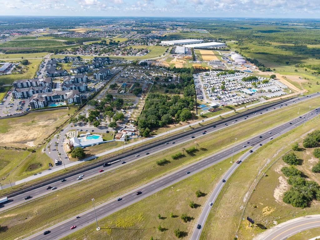 Aerial view of a highway running alongside a residential complex and an RV park — PRIME FRONTAGE, DAVENPORT, FL