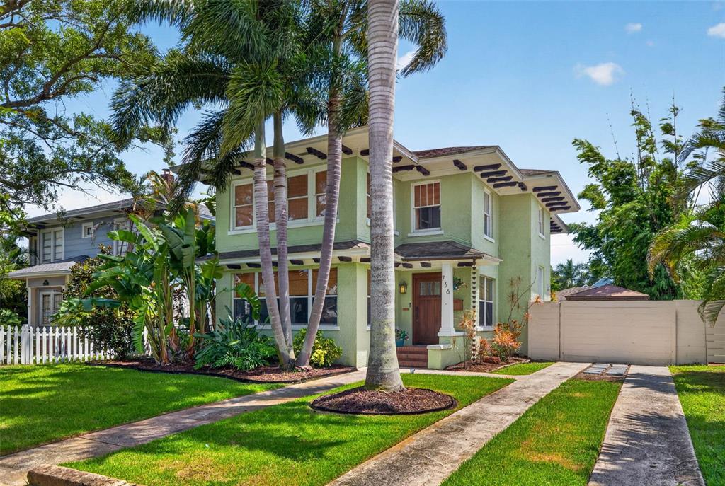 A two-story light green house with a palm tree in the front yard — 736 30TH AVENUE N, ST PETERSBURG, FL