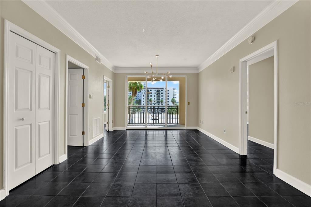 An empty room with black tile floors, white walls, and a balcony with exterior views — 345 BAYSHORE BOULEVARD UNIT 310, TAMPA, FL