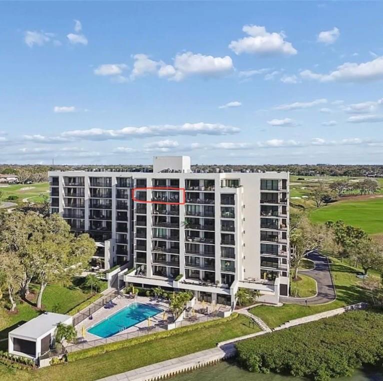 An elevated view of a bay with a residential island and a distant city skyline — 4 BELLEVIEW BOULEVARD UNIT 701, BELLEAIR, FL