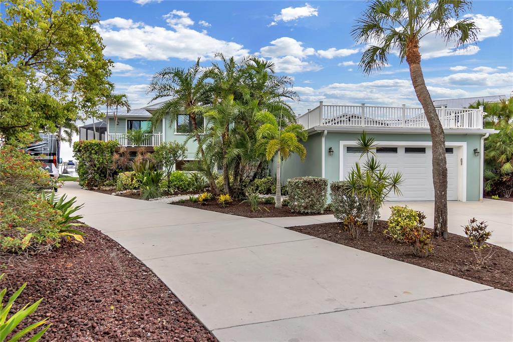 A screened-in patio features a swimming pool, outdoor furniture, and a view of the water — 818 NANCY GAMBLE LANE, ELLENTON, FL