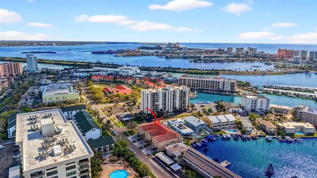 An aerial view shows a multi-story residential complex with a red-roofed building highlighted — 348 LARBOARD WAY, CLEARWATER BEACH, FL
